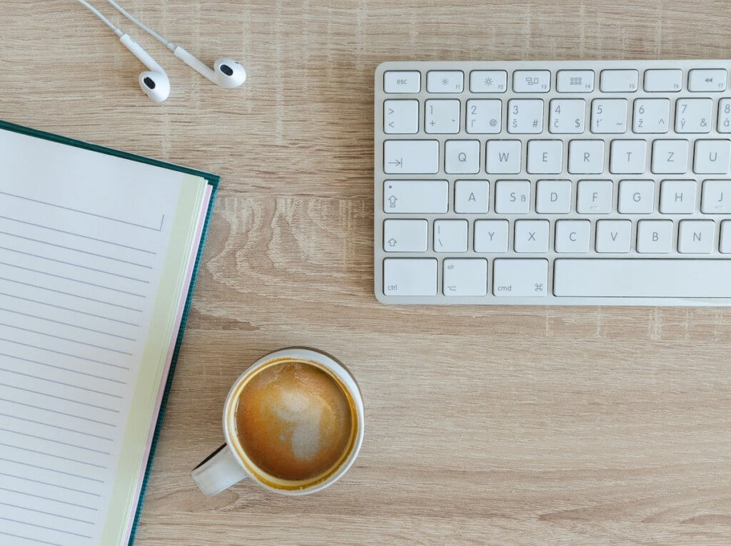 blogging on a keyboard with coffee